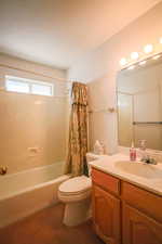 Full bath with vanity, shower / bathtub combination with curtain, and dark carpet