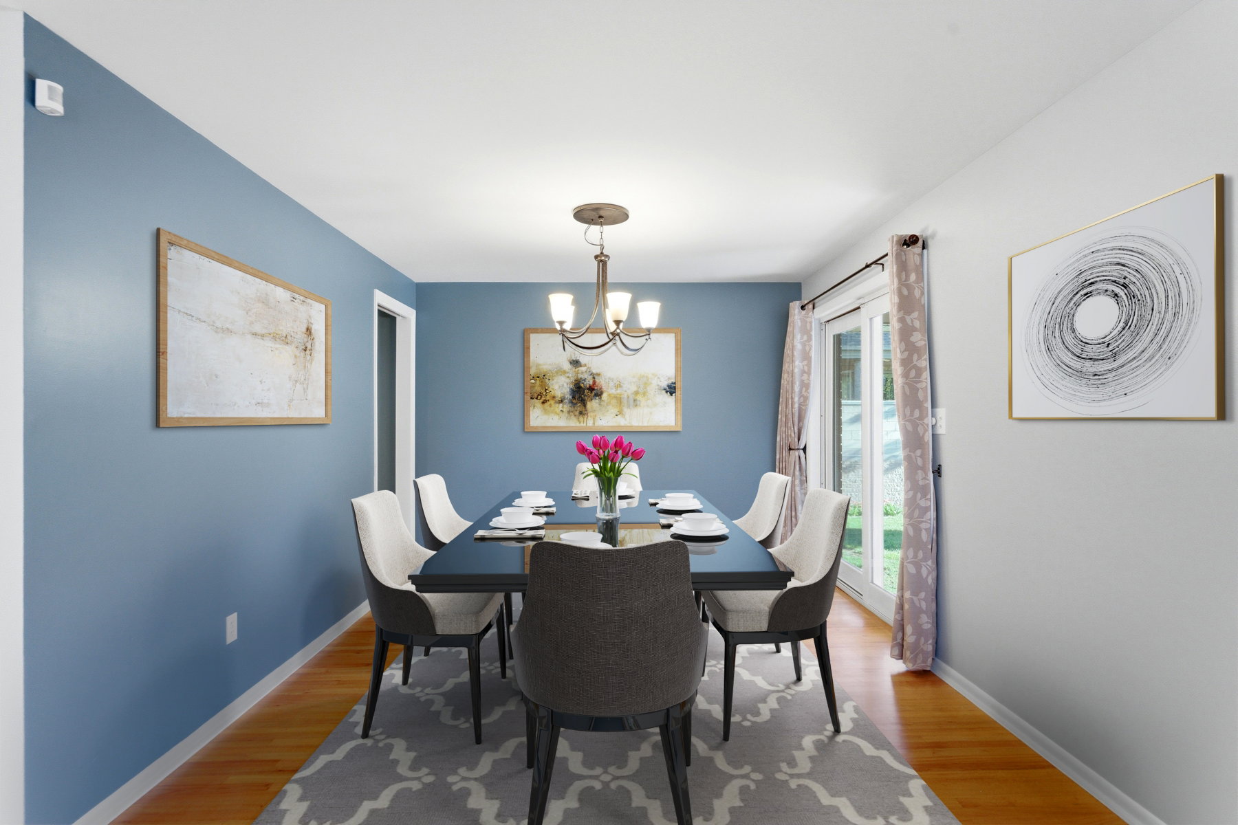 Dining room with light wood-type flooring and a chandelier