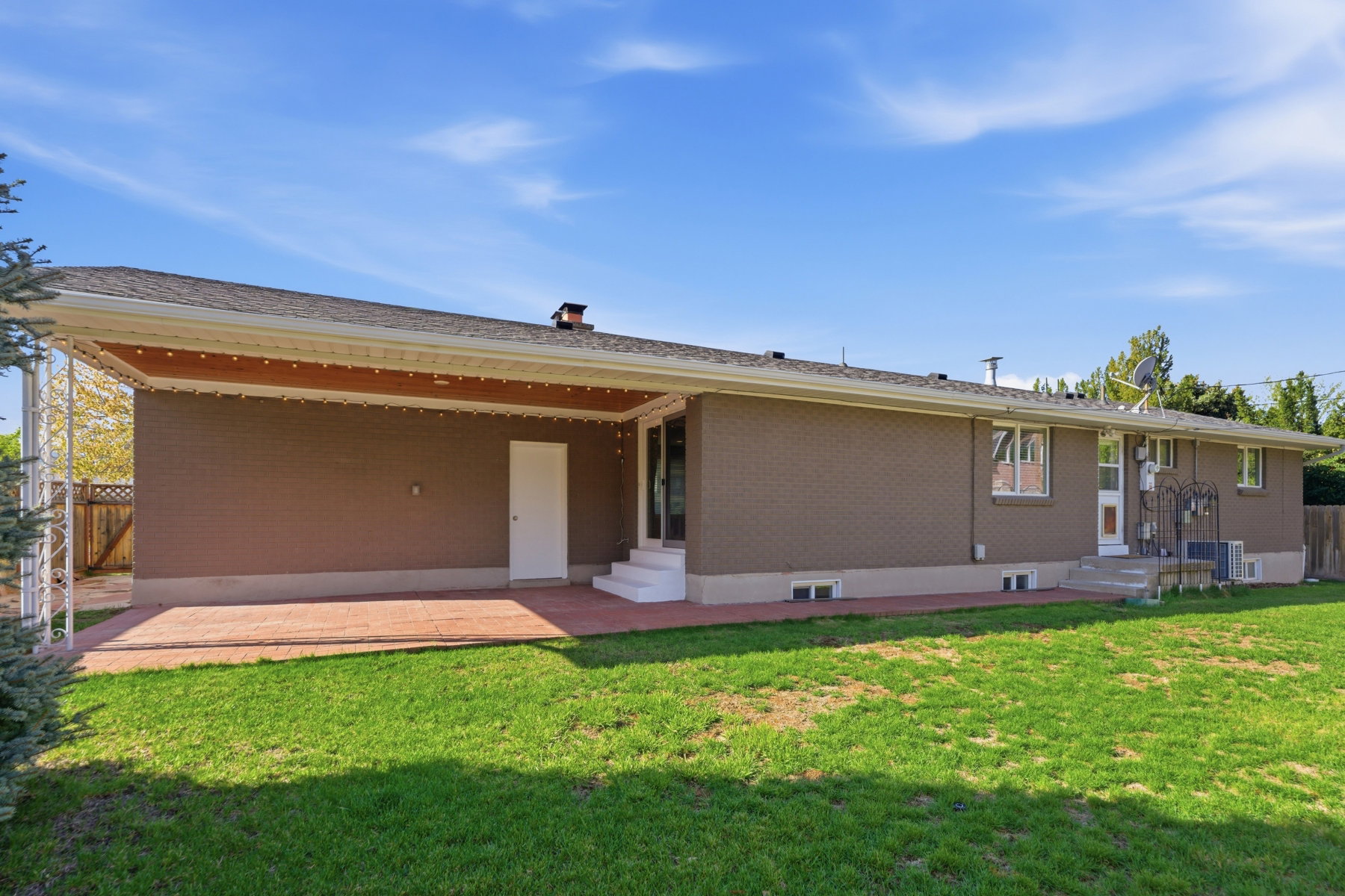 Rear view of property with a patio, brick siding, and entry steps