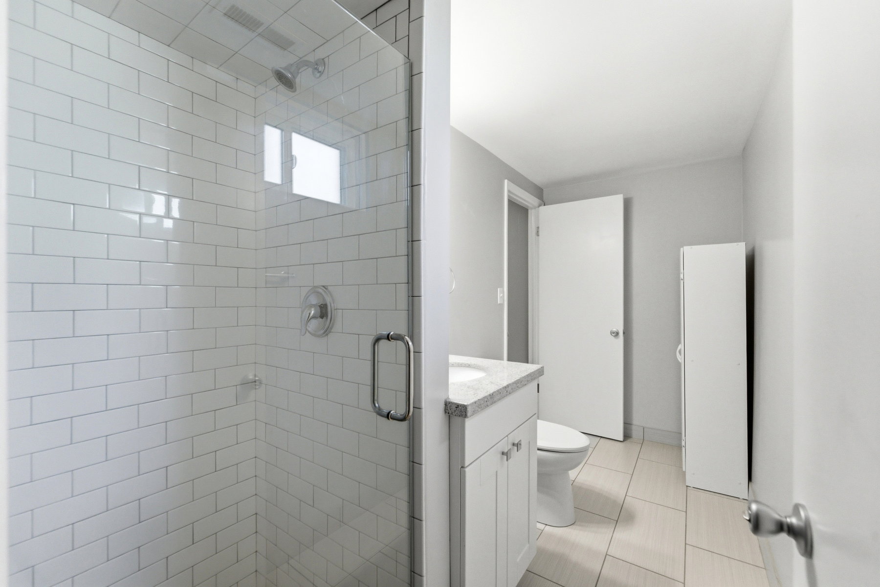 Bathroom featuring vanity, a stall shower, and light tile patterned floors