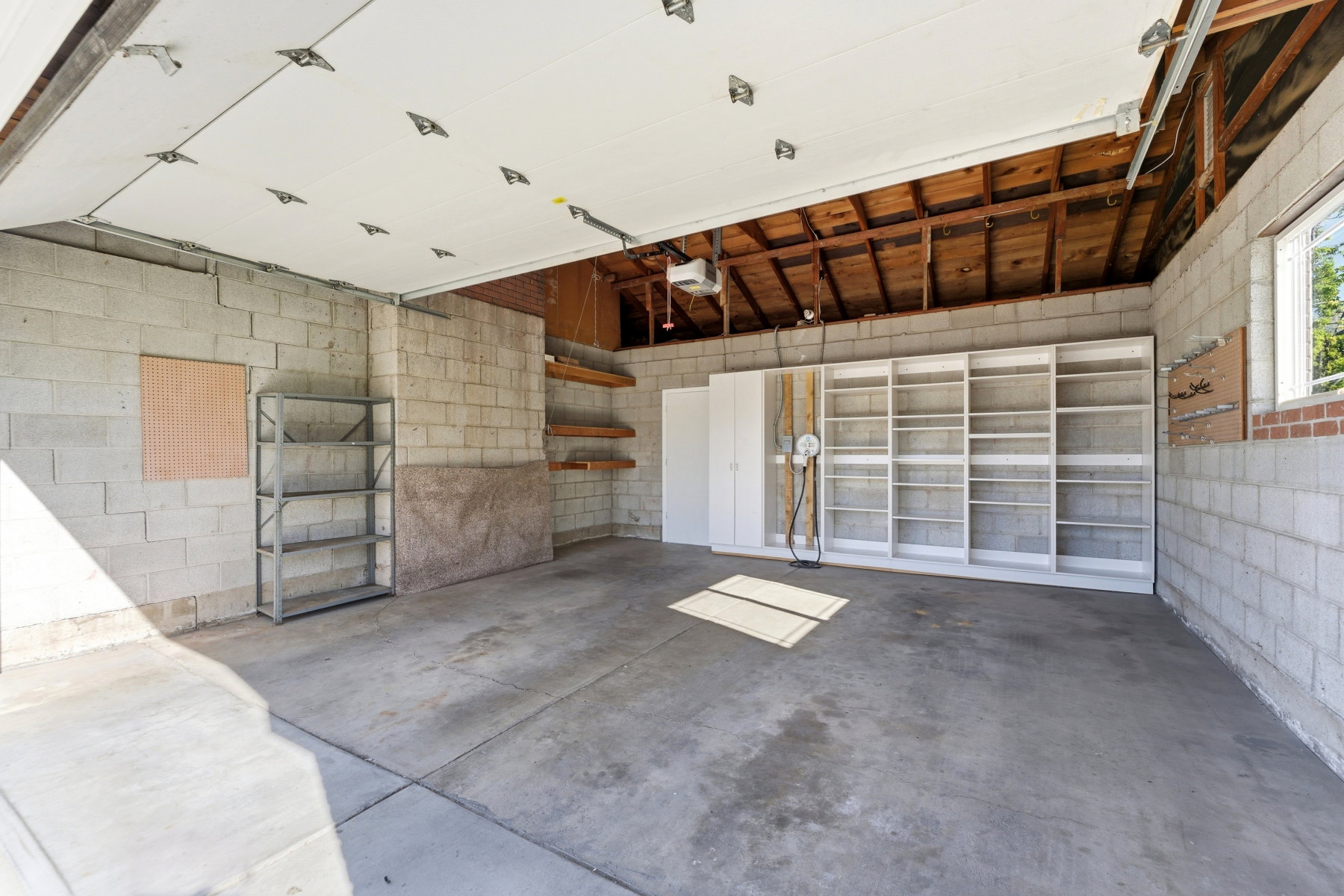 Garage featuring concrete block wall