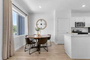 Dining room featuring light wood finished floors and baseboards