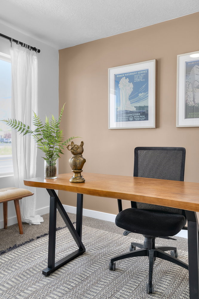 Office area featuring light carpet and a textured ceiling