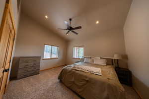 Bedroom featuring dark carpet, lofted ceiling, ceiling fan, and recessed lighting
