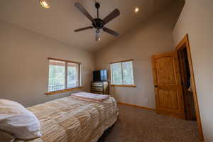 Carpeted bedroom featuring recessed lighting, lofted ceiling, and a ceiling fan