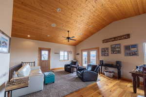 Living area with a vaulted wood ceiling, hardwood / wood-style floors, ceiling fan, french doors, and recessed lighting