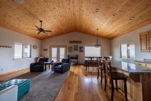 Living area with light wood-type flooring, wooden ceiling, french doors, and a ceiling fan