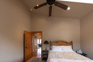 Bedroom with recessed lighting, ceiling fan, carpet flooring, and a high ceiling