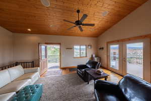 Living area with a vaulted wooden ceiling, a ceiling fan, light wood-style flooring, french doors, and recessed lighting