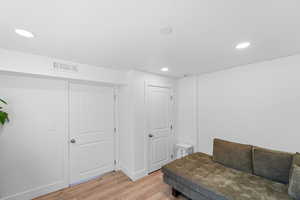 Living area featuring light wood-type flooring and recessed lighting