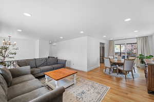 Living area featuring light wood-type flooring and hanging lights