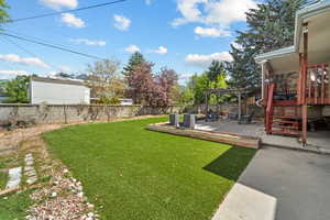 Fenced backyard with a wooden deck and a pergola