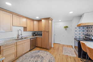 Kitchen featuring stainless steel appliances, light stone countertops, light wood-style flooring, recessed lighting, and light wood finish cabinetry