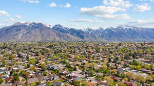 Aerial view of residential area featuring a mountainous background