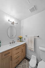 Half bath with vanity and toilet