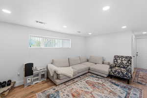 Living area featuring light wood-style flooring and recessed lighting