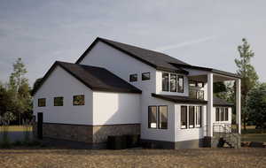 Rear view of house featuring stucco siding and a shingled roof