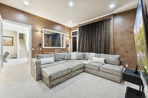 Living area with carpet floors and recessed lighting