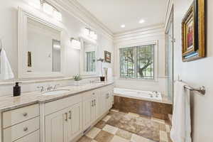 Bathroom featuring double vanity and a bath