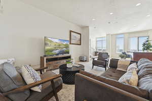 Living room featuring recessed lighting, light colored carpet, and a textured ceiling