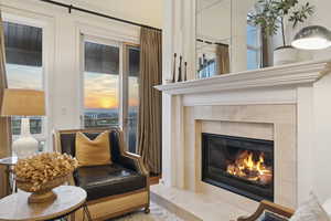 Living area with a tile fireplace and plenty of natural light