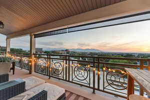 Balcony at dusk featuring a mountain view