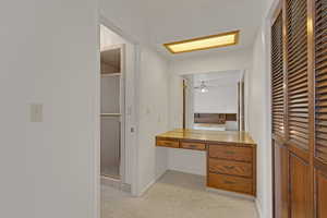 Full bath with a shower stall and a ceiling fan