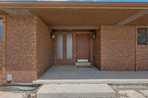 Entrance to property featuring brick siding