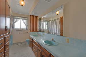 Full bath with double vanity and a shower with shower curtain