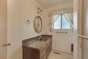 Bathroom featuring vanity and baseboards