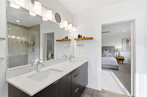 Full bath featuring double vanity, ensuite bath, recessed lighting, a stall shower, and light carpet