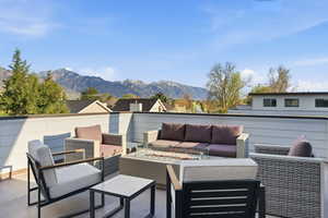 View of patio with a mountain view and outdoor seating