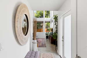 Entrance foyer with light wood-type flooring