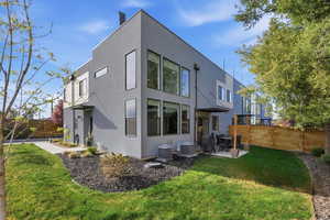 Rear view of property featuring a fenced backyard, a patio area, and stucco siding