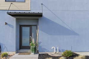 View of exterior entry with stucco siding