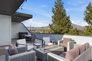 View of patio / terrace with a mountain view, an outdoor fire pit, and outdoor lounge area