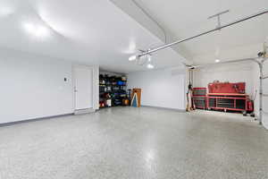 Garage featuring baseboards
