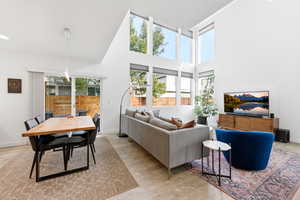 Living area featuring a high ceiling and light wood-style flooring