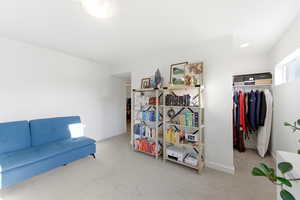 Living area featuring light carpet