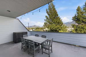 View of patio with a mountain view and outdoor dining space