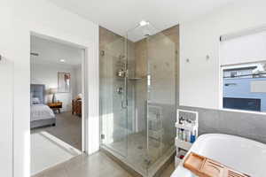 Full bath featuring ensuite bath, a stall shower, carpet, a bath, and tile patterned floors