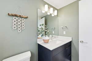 Half bath with vanity and toilet