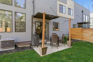 Back of house featuring stucco siding, a patio, and outdoor dining area