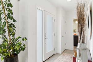 Foyer featuring light tile patterned floors and baseboards