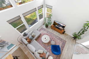 Living room featuring a high ceiling and wood finished floors