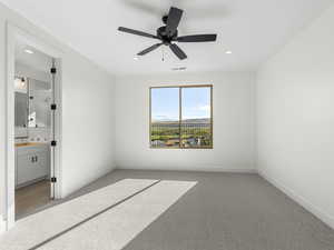 Unfurnished bedroom with carpet floors, a ceiling fan, recessed lighting, and ensuite bathroom