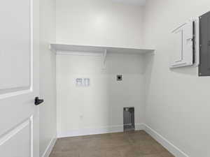 Laundry area with hookup for an electric dryer, electric panel, and hookup for a washing machine