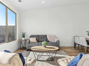 Living room with wood finished floors and recessed lighting