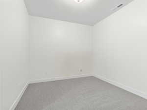Carpeted empty room with baseboards
