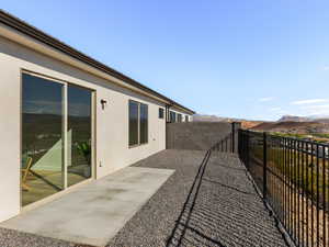 Fenced backyard featuring a patio and a mountain view